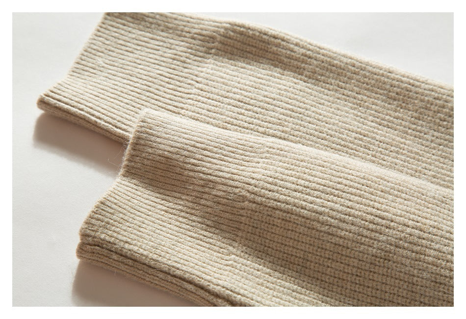 Close-up of the beige sweater's ribbed sleeve cuffs.