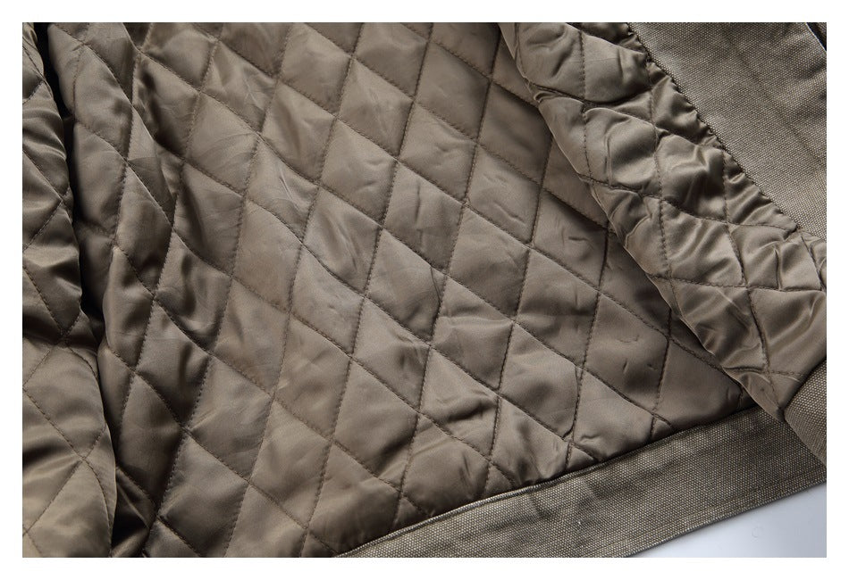 Close-up of taupe-brown diamond quilting beside a darker textured fabric edge.