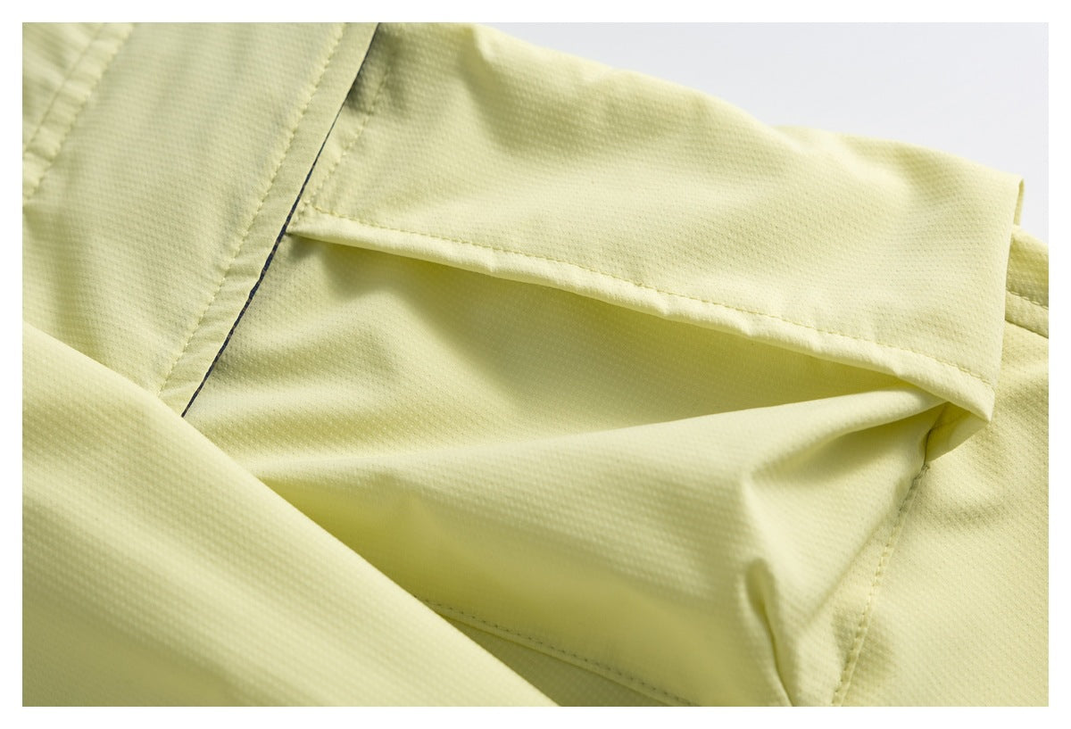 Close-up of a pale yellow garment pocket opening and stitched seams.