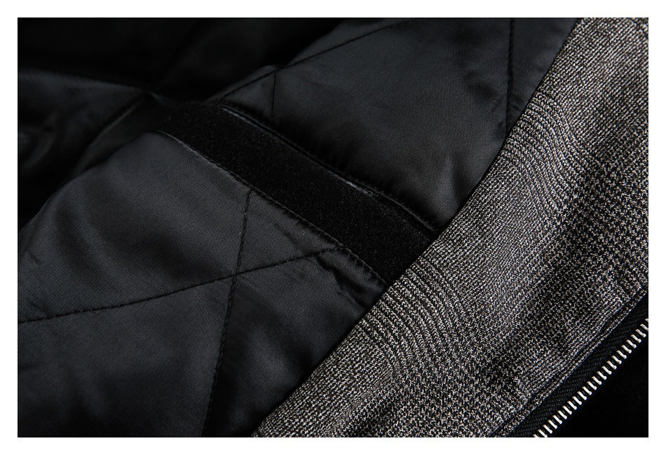 Close-up of a garment interior with black lining, a gray patterned panel, and a zipper edge.