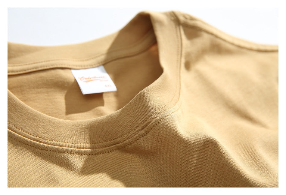 Close-up of the tan T-shirt's ribbed crew neckline and inner neck label.