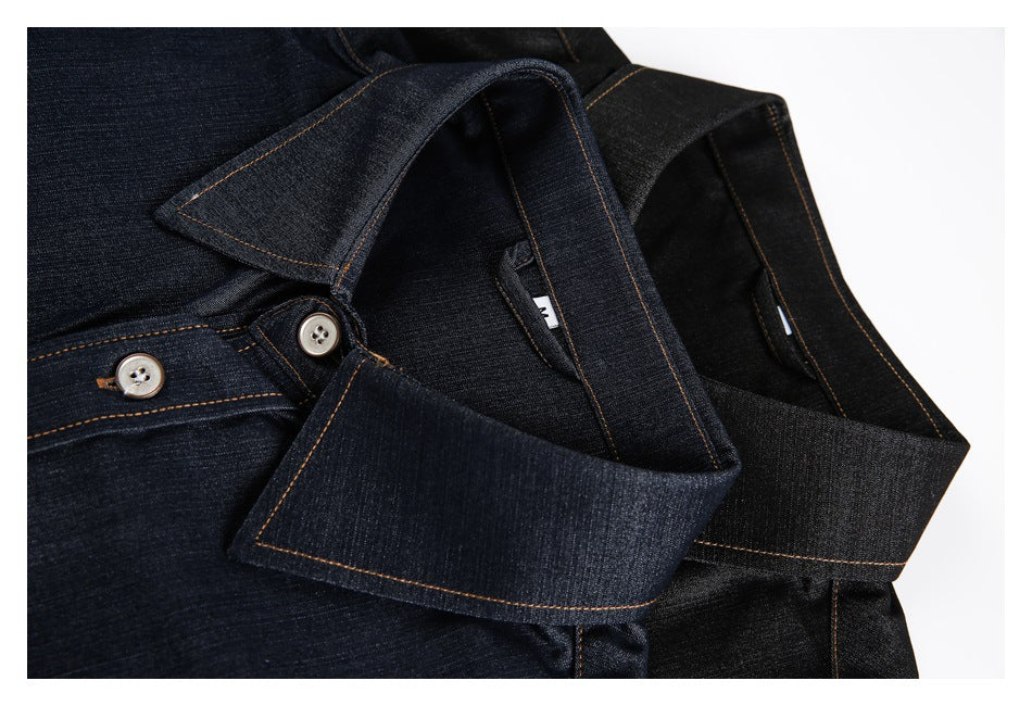 Close-up of dark indigo and black denim shirt collars with orange contrast stitching and buttoned plackets.