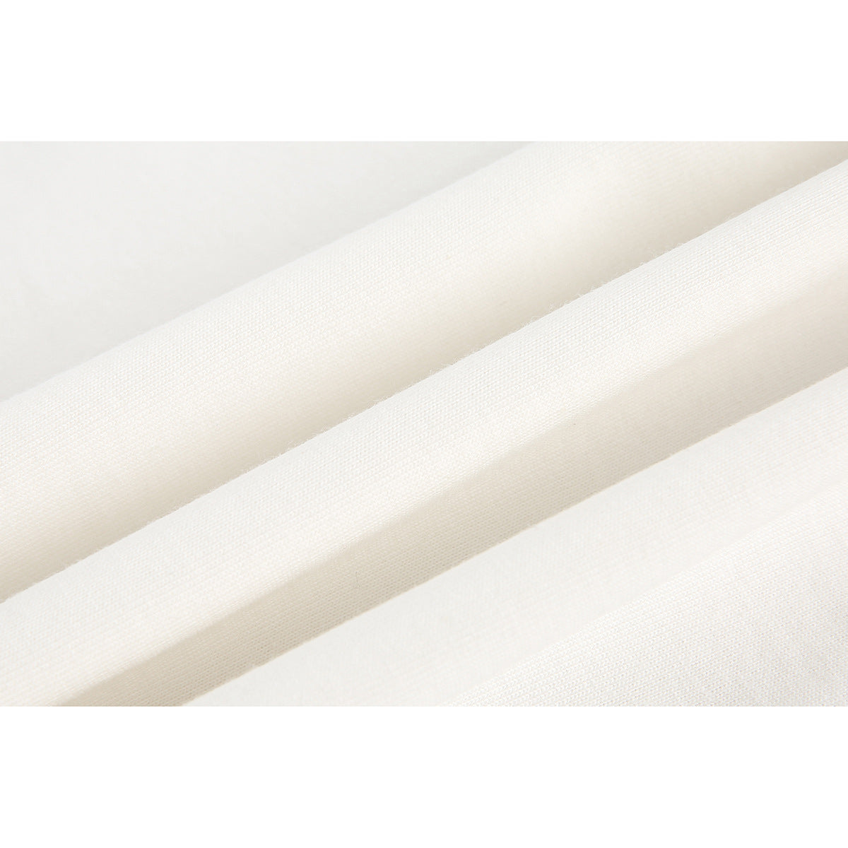 Extreme close-up of off-white fabric showing its fine woven texture and folds.