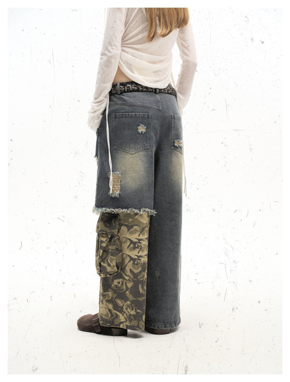 Rear view of a model wearing wide-leg faded denim pants with distressed patches and a camouflage cargo panel on one leg.