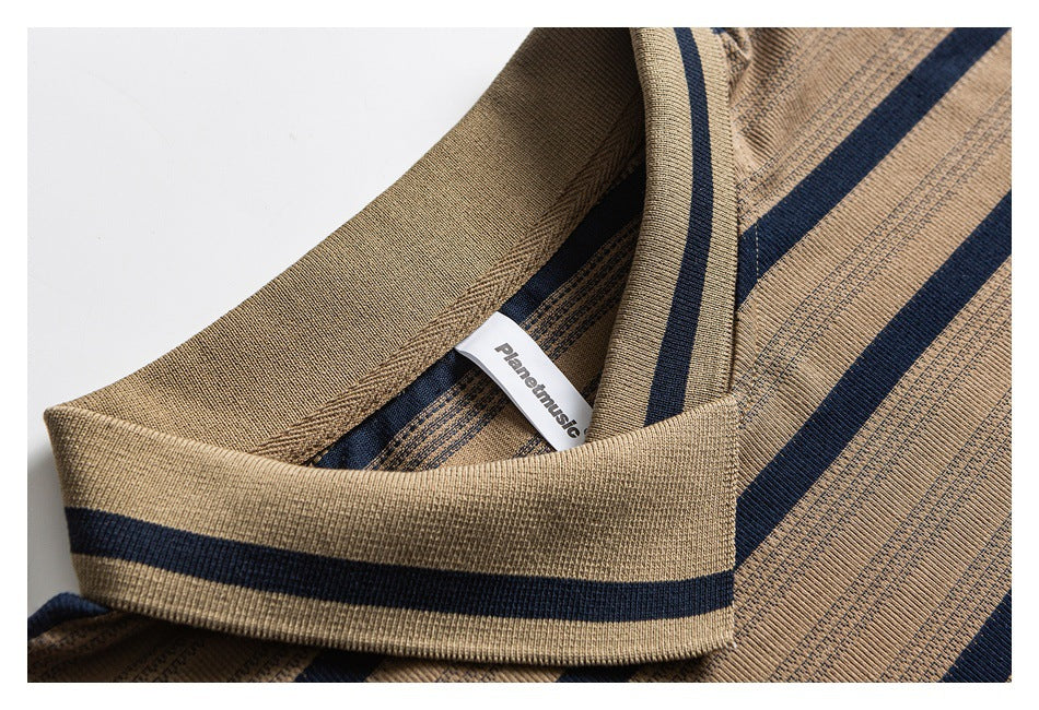 Close-up of a tan knit neckline with navy stripes and a small white brand label.