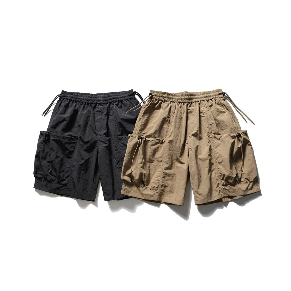 Black and taupe cargo shorts shown together, each with an elastic waist and large adjustable side pockets.