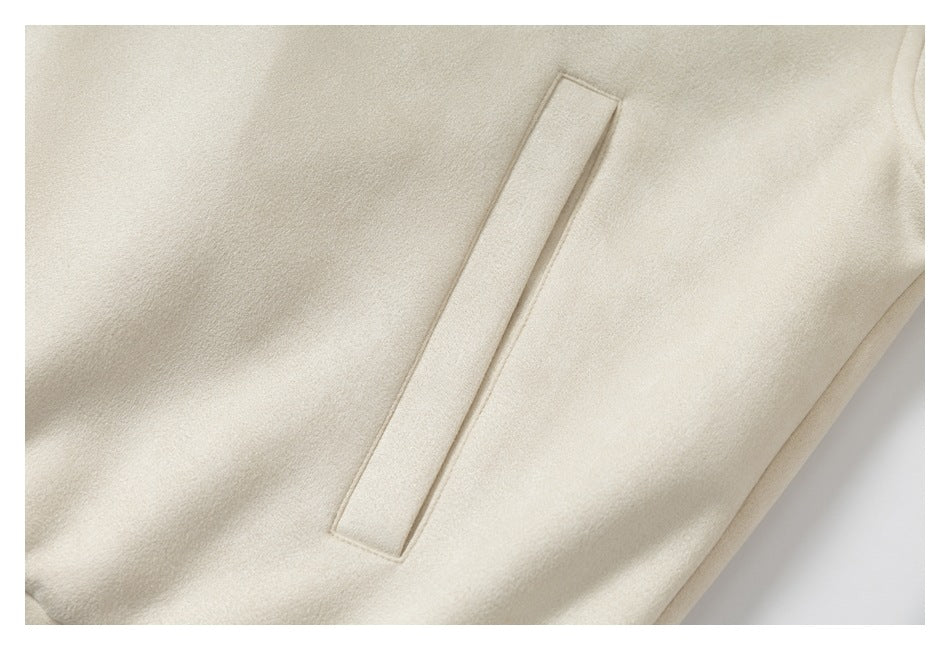 Close-up of a narrow welt pocket on a cream garment.