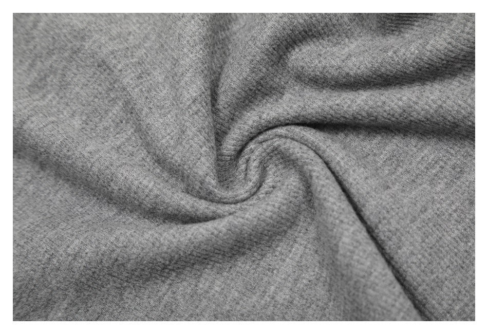 Close-up of the gray knit fabric gathered into soft folds.