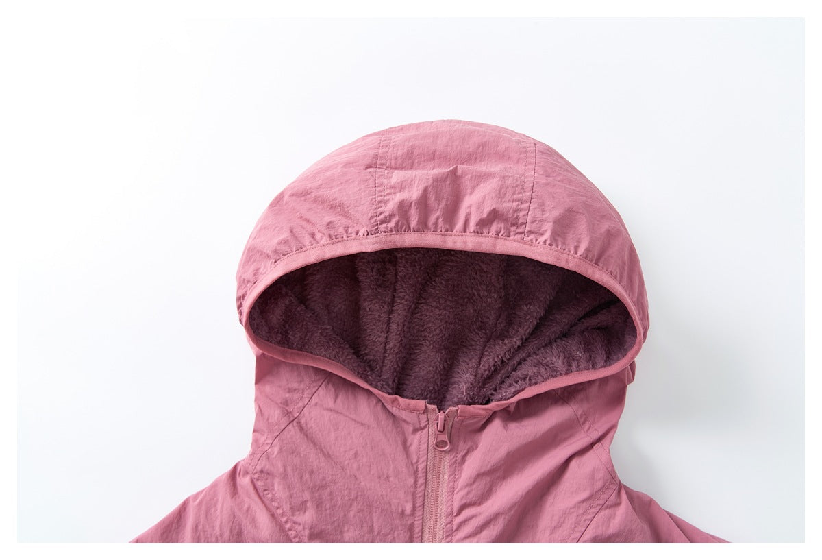 Close-up of a dusty pink jacket hood with dark mauve plush lining and a front zipper.