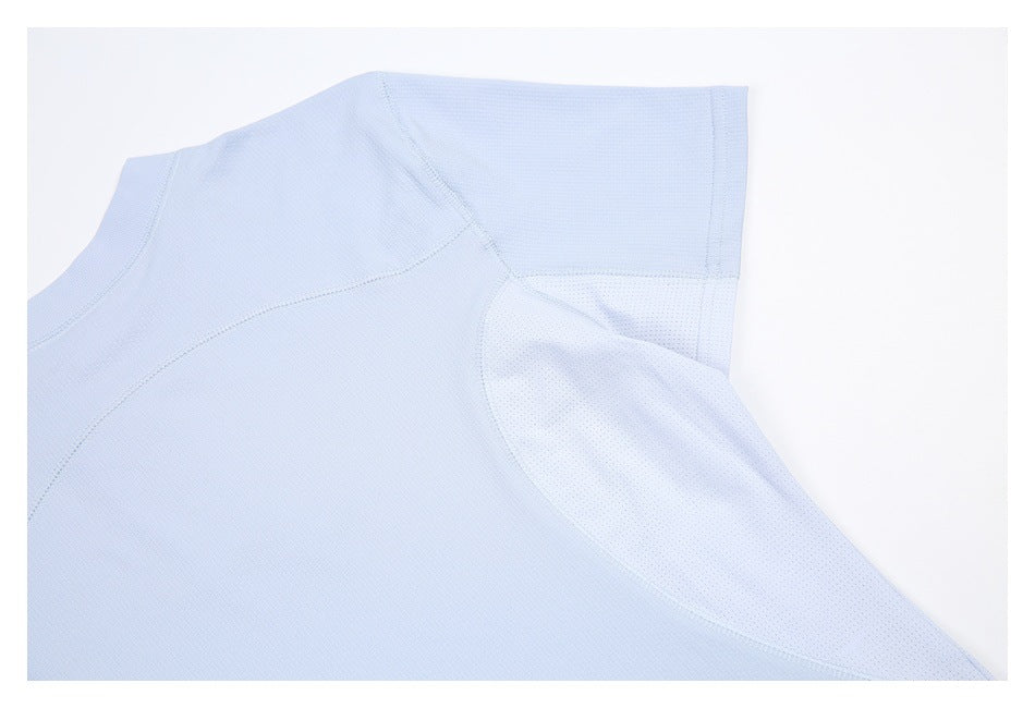 Partial flat lay of a light blue shirt showing the shoulder, sleeve, and perforated underarm panel.