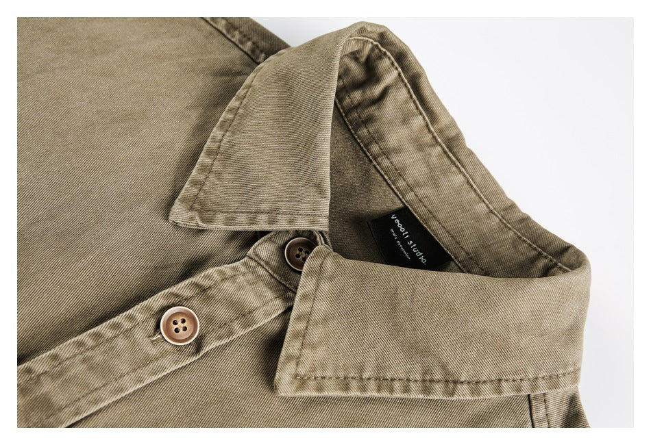 Close-up of a tan shirt collar, placket, buttons, and a small black neck label.