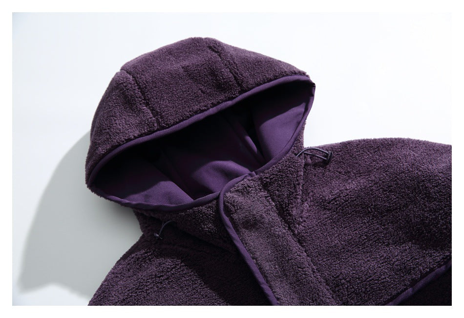 Close-up of the dark purple fleece jacket's hood, showing its smooth purple lining and bound edge.