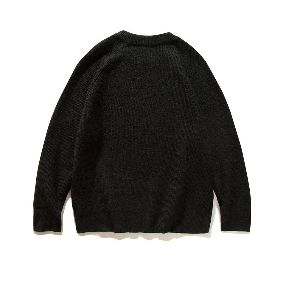 Back view of a black ribbed knit crew-neck raglan-sleeve sweater
