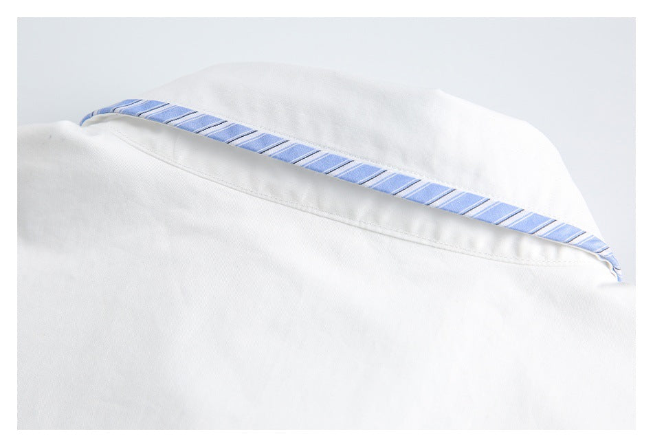 Close-up of the back collar of a white shirt, with blue-striped trim inside.