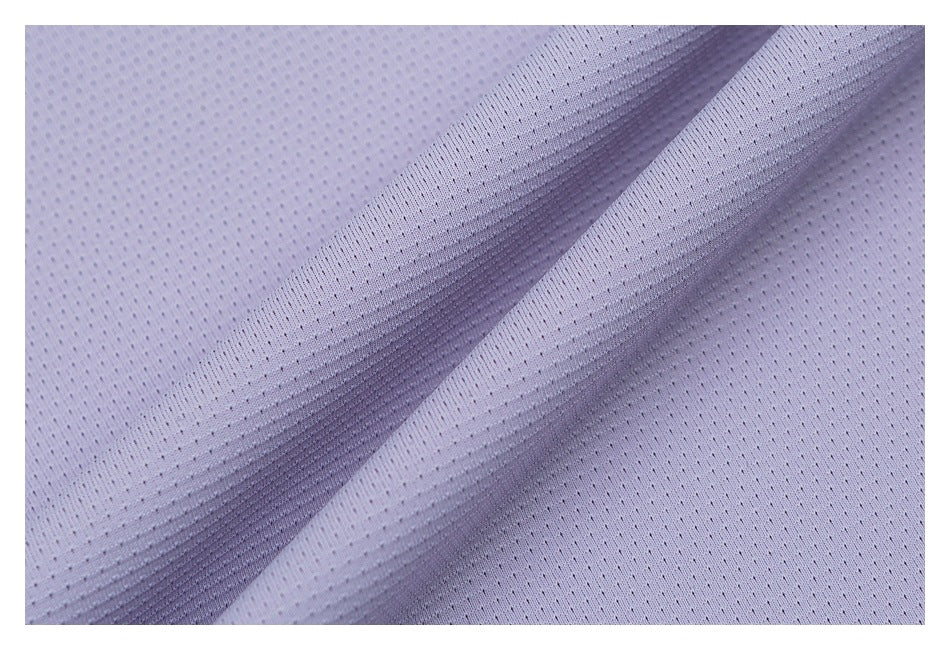Close-up of lightweight-looking lavender fabric with a perforated texture and soft folds.