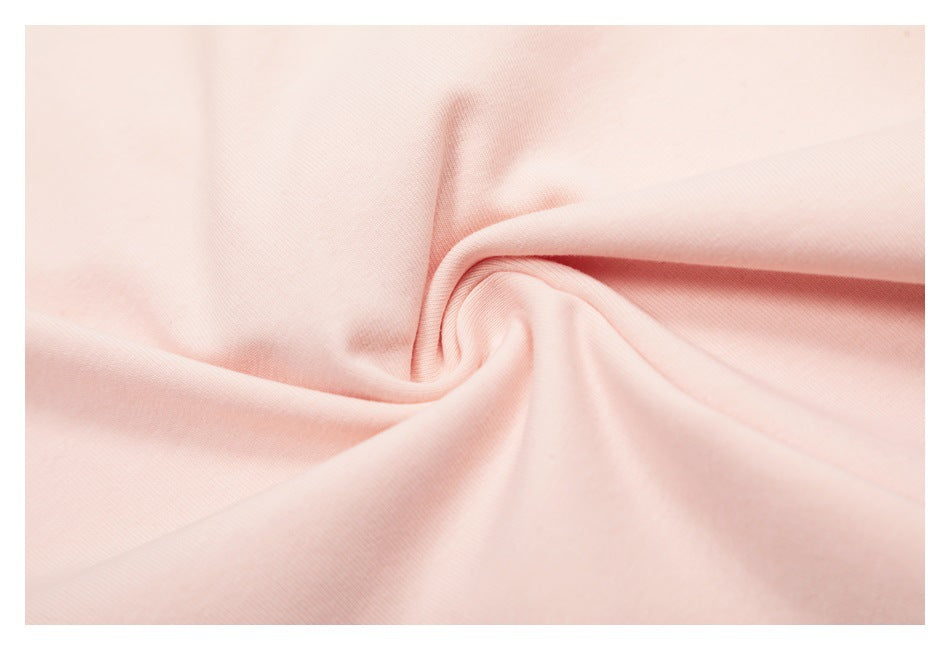 Close-up of pale pink fabric loosely folded to show its surface and drape.