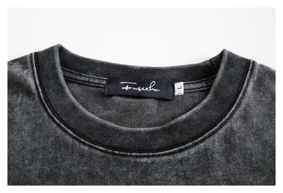 Close-up of a dark charcoal crew neckline, ribbed collar, and sewn-in label with an L size tag.