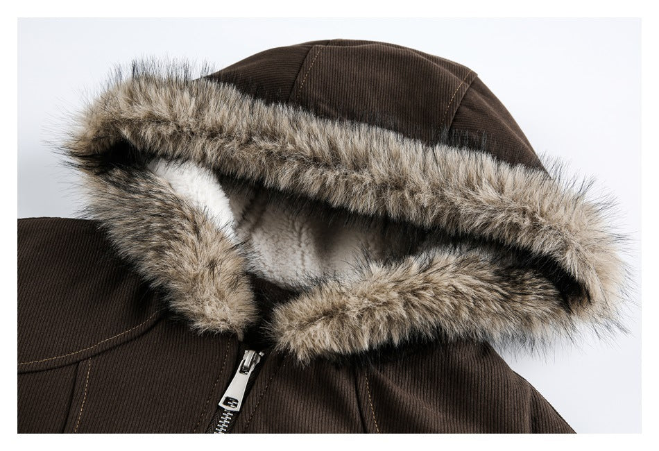 Close-up of a brown jacket hood edged with thick mottled faux fur, showing the pale lining and front zipper.