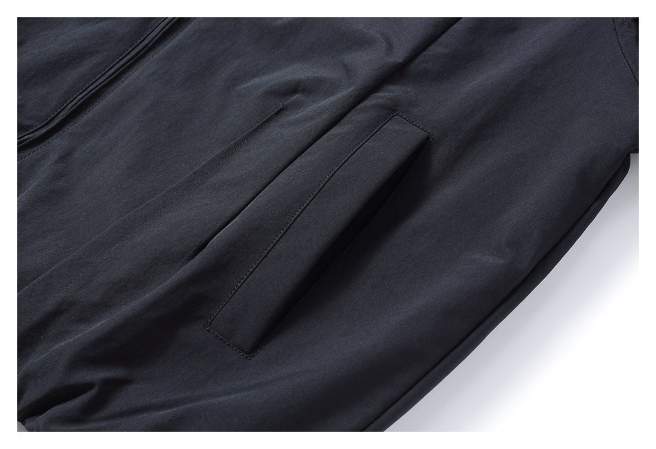 Close-up of dark trousers with a slanted welt pocket.