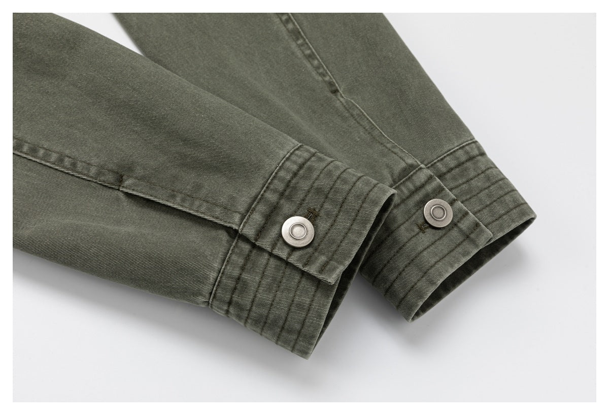 Close-up of olive-gray jacket sleeves with buttoned cuffs and multiple rows of stitching.