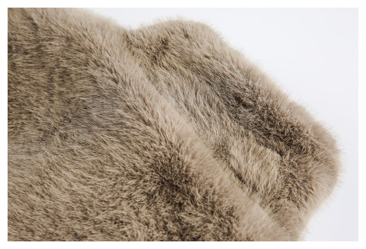 Close-up of a folded edge of brown faux fur with lighter tips and a plush rounded border.