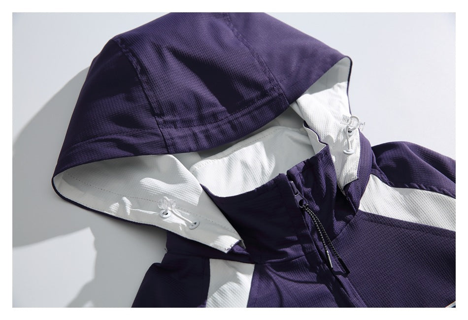 Close-up of the purple jacket's hood, white lining, drawcords, and upper front zipper.