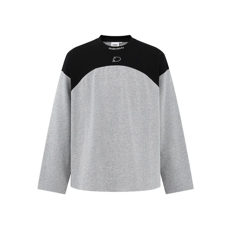Gray long-sleeve crew neck top with black curved shoulder yoke and small embroidered logo, flat front view