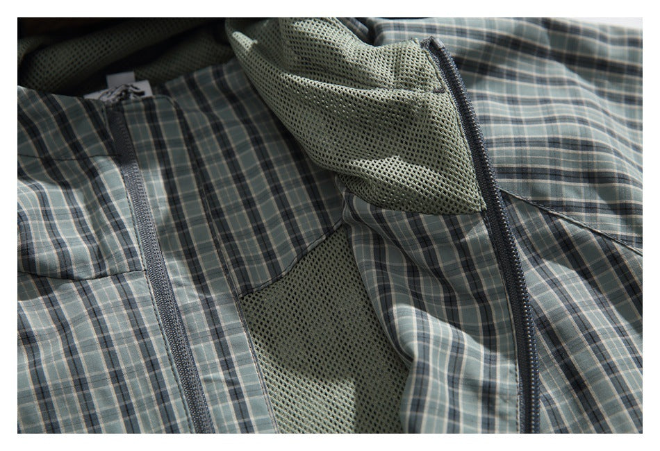 Open gray-green plaid jacket showing its mesh lining and front zipper.