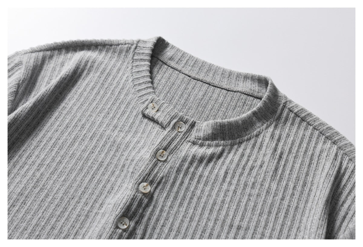 Close-up of a heather gray ribbed henley shirt's band collar and button placket.