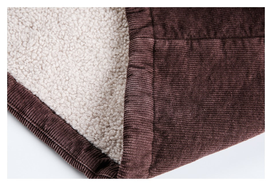 Close-up of the jacket's cream sherpa lining beside its plum-brown ribbed outer fabric and bound edge.