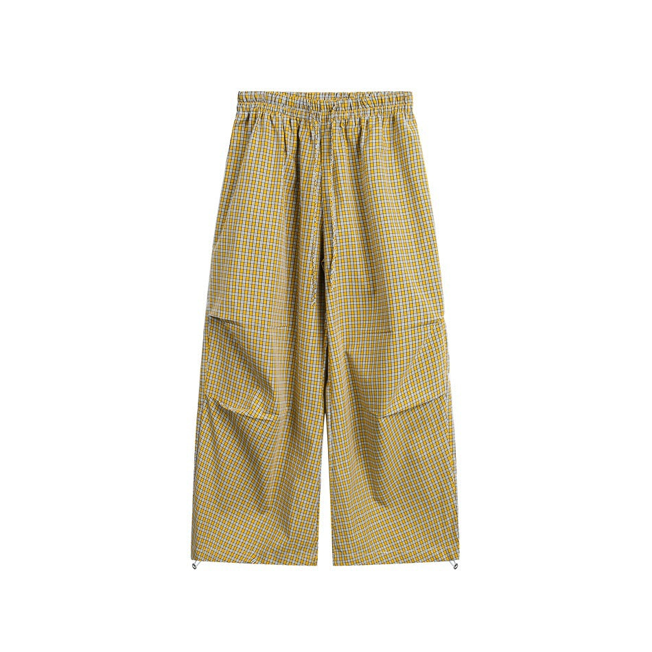 Yellow small-check wide-leg pants with elastic drawstring waist and toggle hems, flat front view
