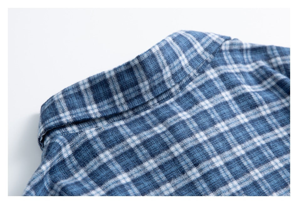 Close-up of the collar and shoulder area of a blue-and-white plaid shirt.
