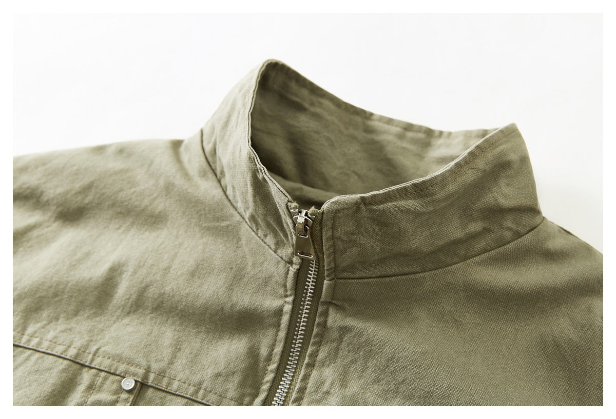 Close-up of the olive-khaki jacket's stand collar and front zipper.
