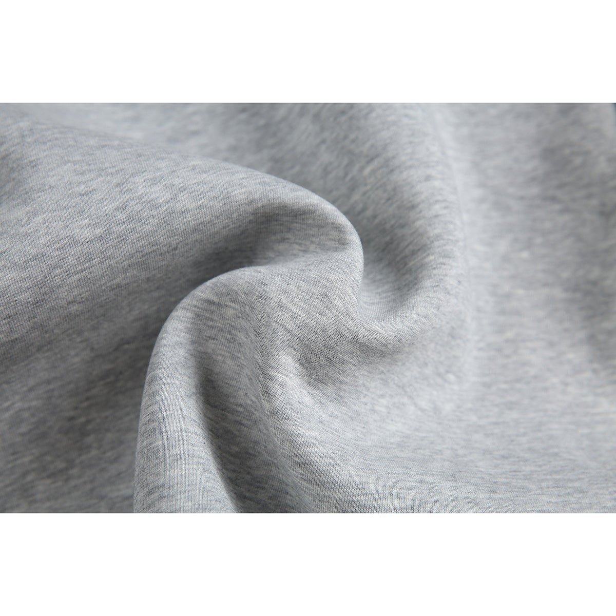 Close-up of the heather-gray garment fabric, draped to show its surface and folds.