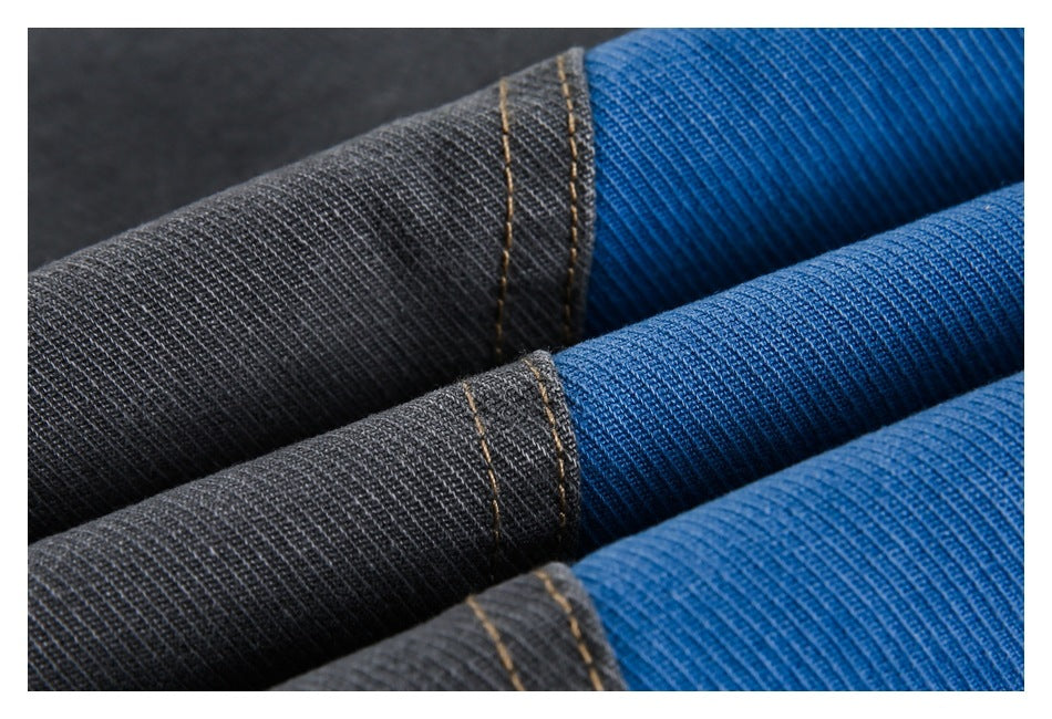 Close-up of black and blue ribbed fabric with tan stitching along the edges.