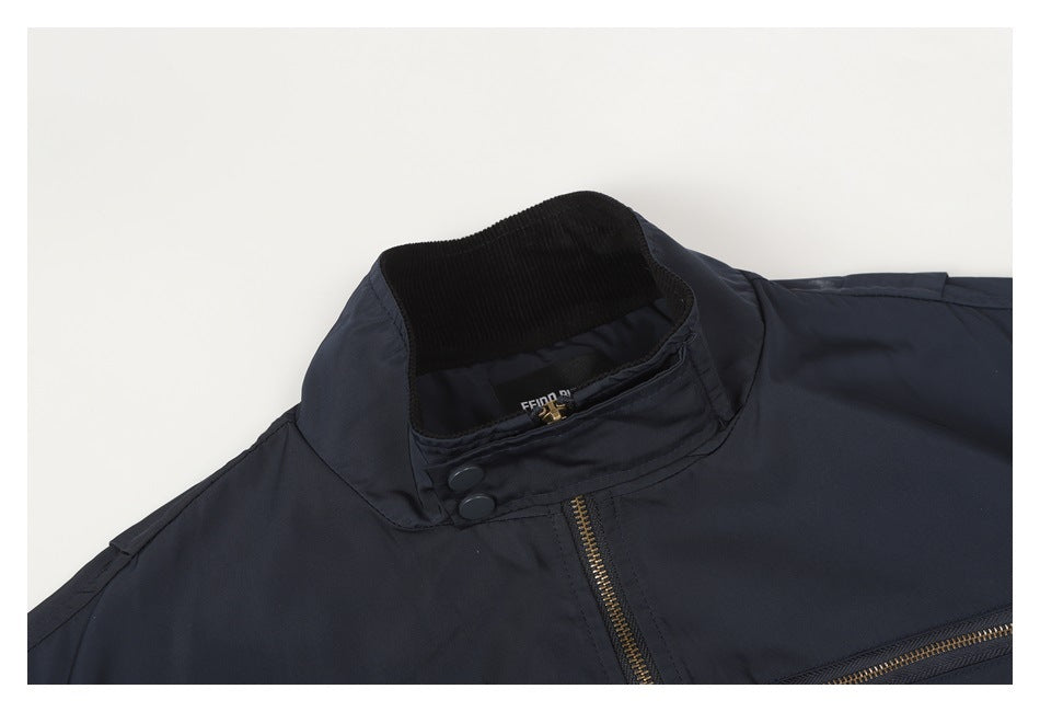 Close-up of the navy jacket's raised collar, black ribbed lining, snap buttons, and brass-tone zipper.