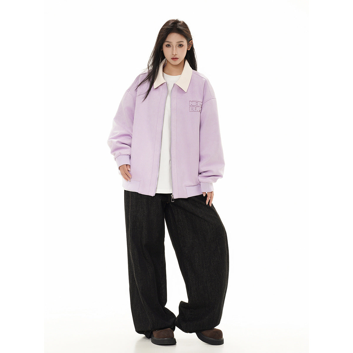 Front view of a model wearing a lilac jacket with a cream collar, white shirt, and loose black trousers.