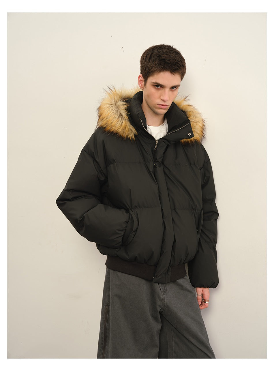 Man modeling a black puffer jacket with a tan fur-trimmed hood, shown from the front at a closer angle.