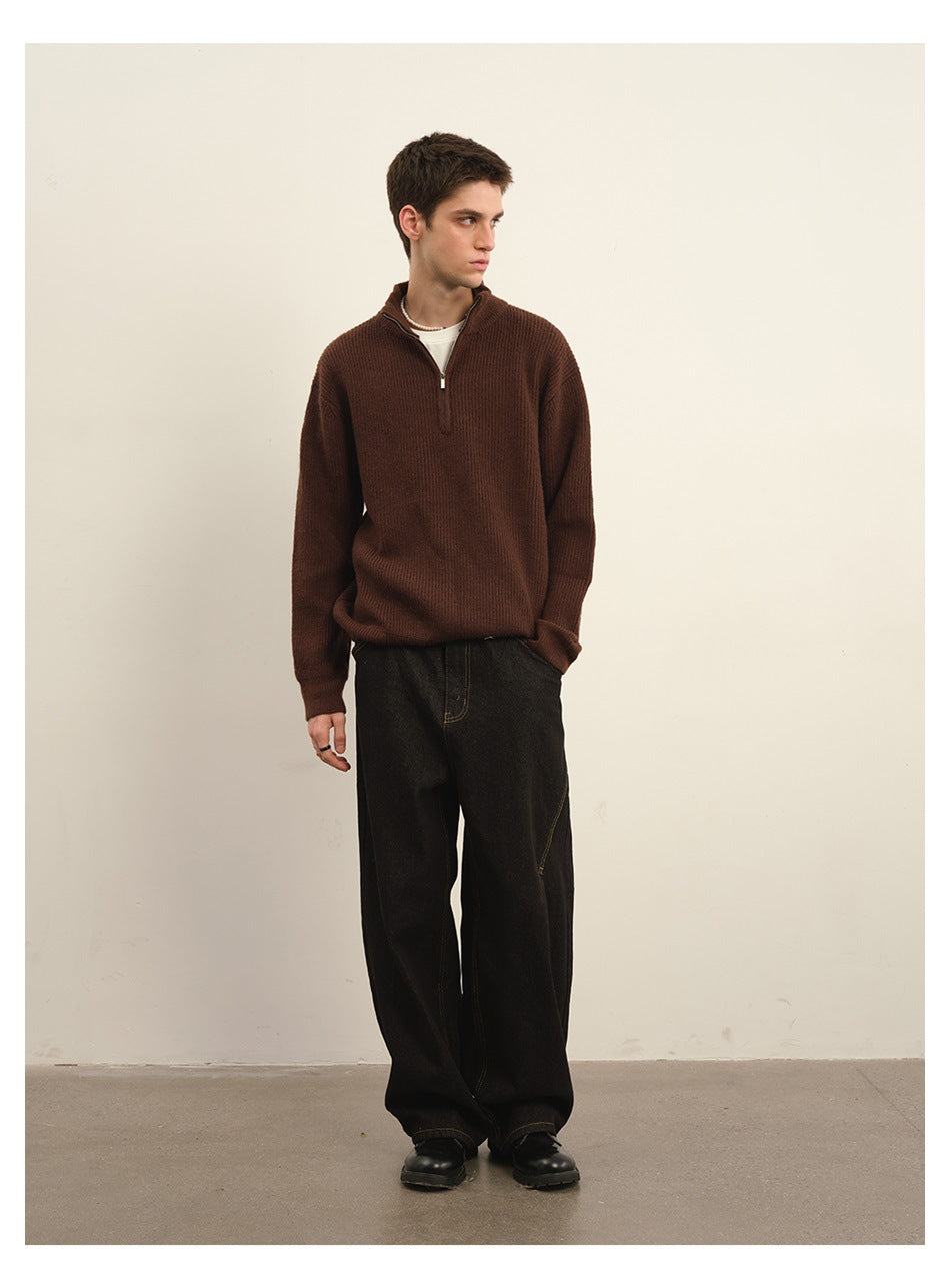 Model wearing a brown ribbed quarter-zip sweater with dark wide-leg trousers.