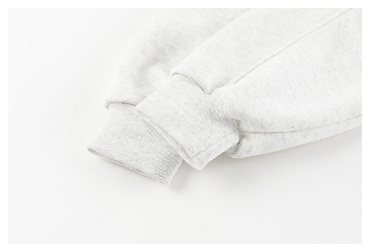 Close-up of a ribbed cuff and sleeve on a light gray sweatshirt.