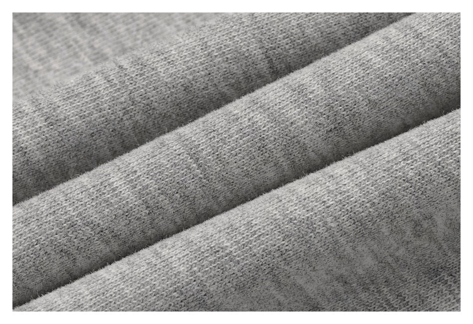 Extreme close-up of heather-gray knit fabric arranged in soft folds.
