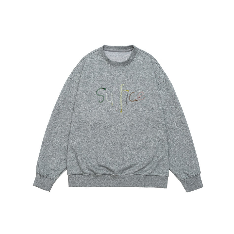 Heather gray crew-neck sweatshirt flat lay with ribbed trim and colorful zipper-style lettering graphic on chest