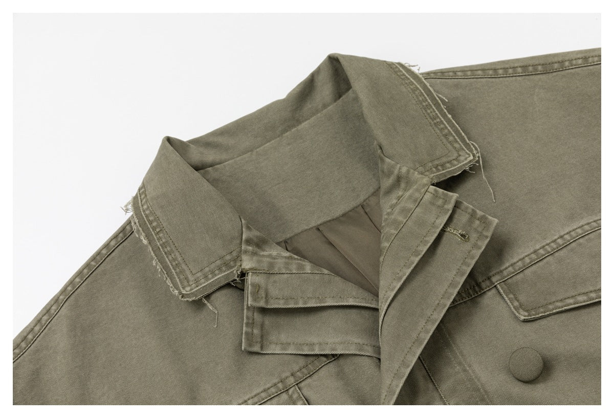 Close-up of the olive-gray jacket's collar, lapels, inner facing, stitching, and a covered front button.