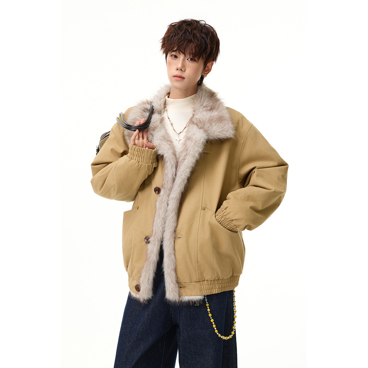 Model wearing a tan jacket with a wide pale faux-fur collar and front trim.