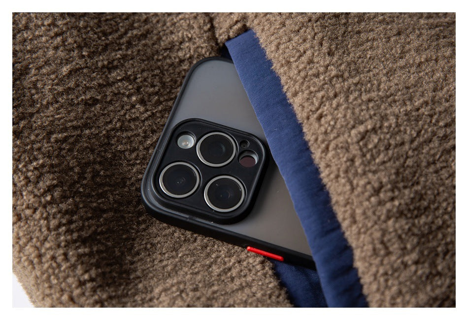 Close-up of a smartphone tucked into a pocket in brown textured fleece with navy trim.