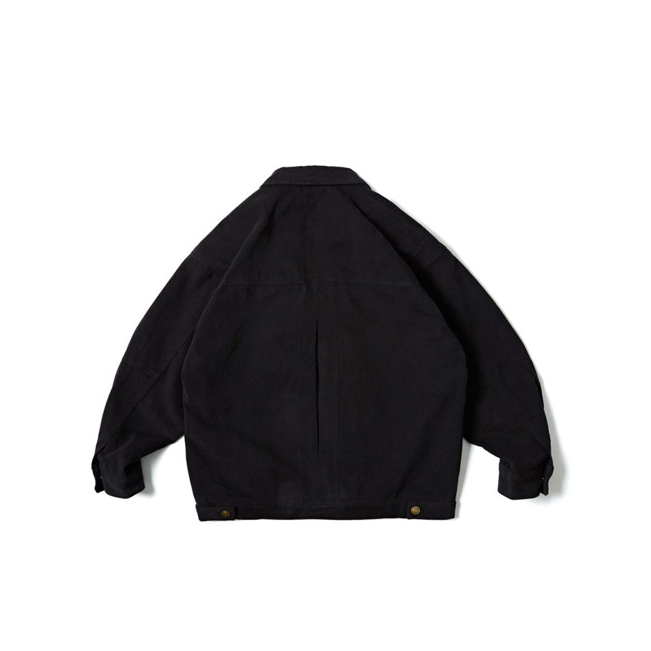 Back view of a black work jacket with a center pleat, panel seams, and snap-adjustable hem tabs.
