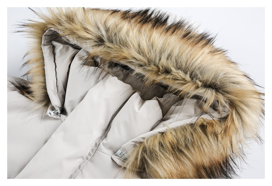 Close-up of the tan and black faux-fur hood trim and lining on a light gray puffer jacket.