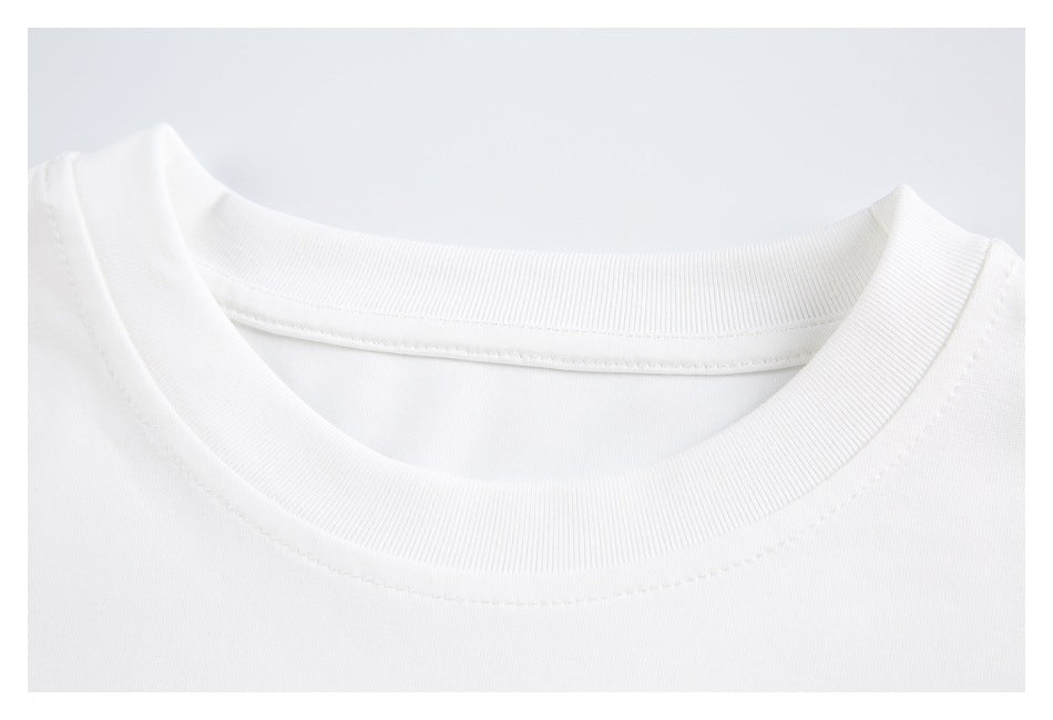 Close-up of the ribbed crew neckline and stitching on a plain white shirt.