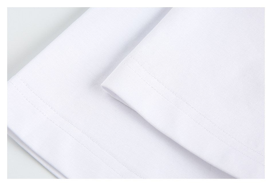 Close-up of a folded white garment hem with visible stitching.