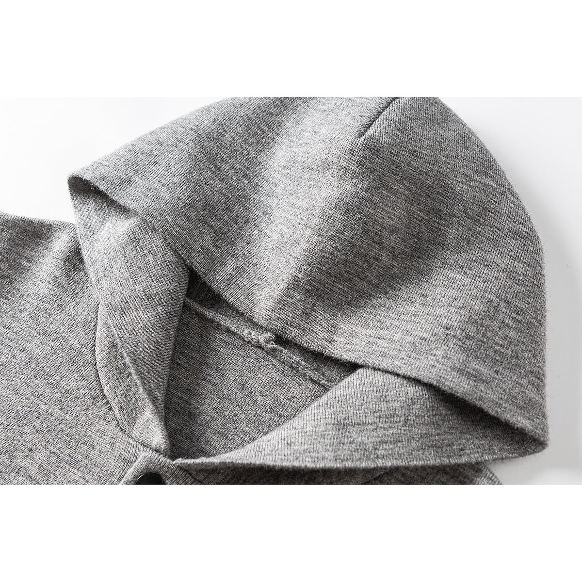 Close-up of a heather gray hood and neckline on a button-front knit cardigan.